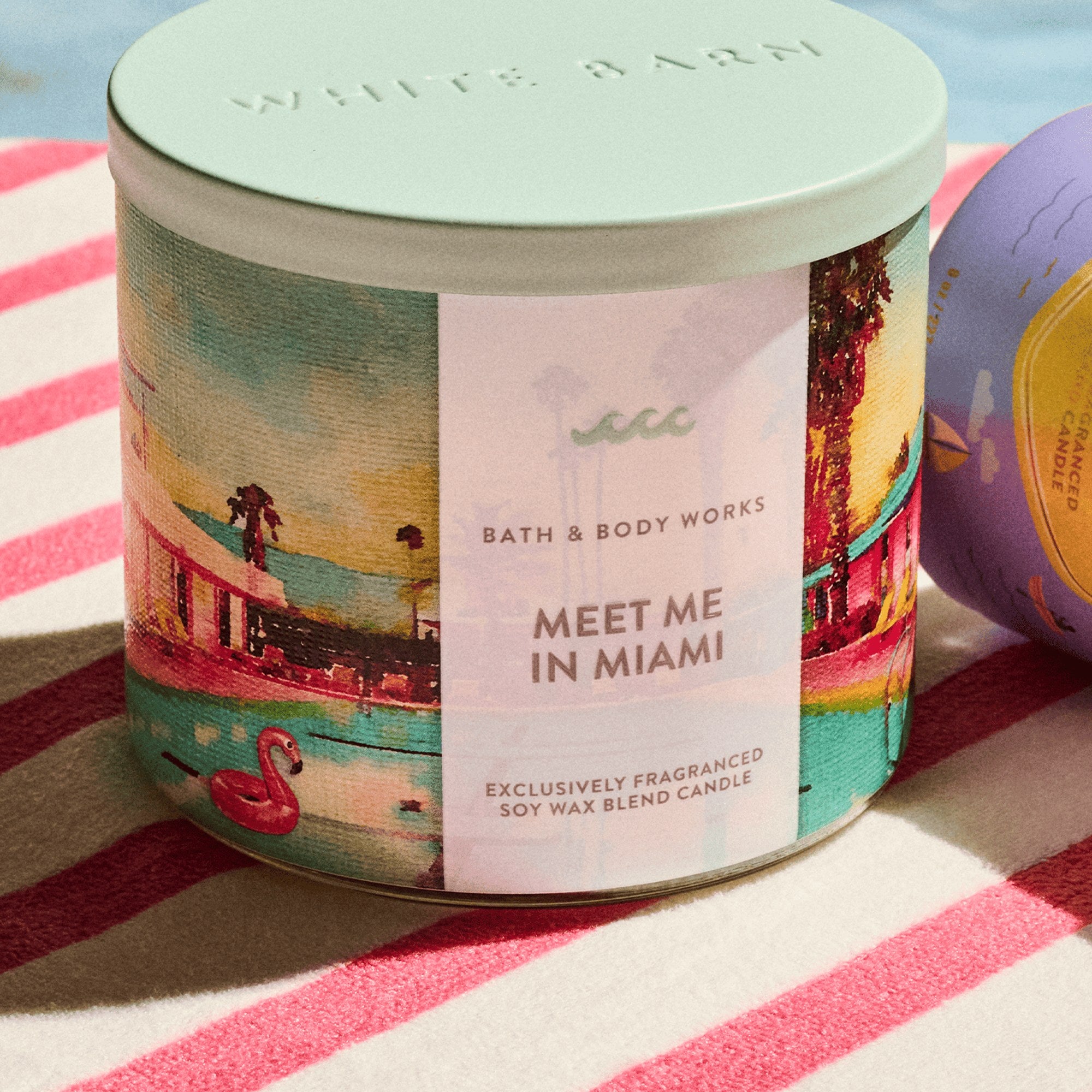 Meet Me in Miami candle on a striped summer towel